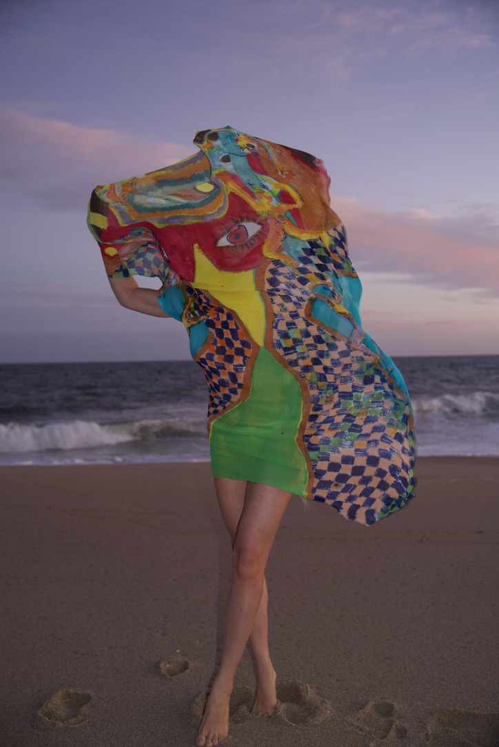 Hand-painted silk wearable piece on the beach at dusk